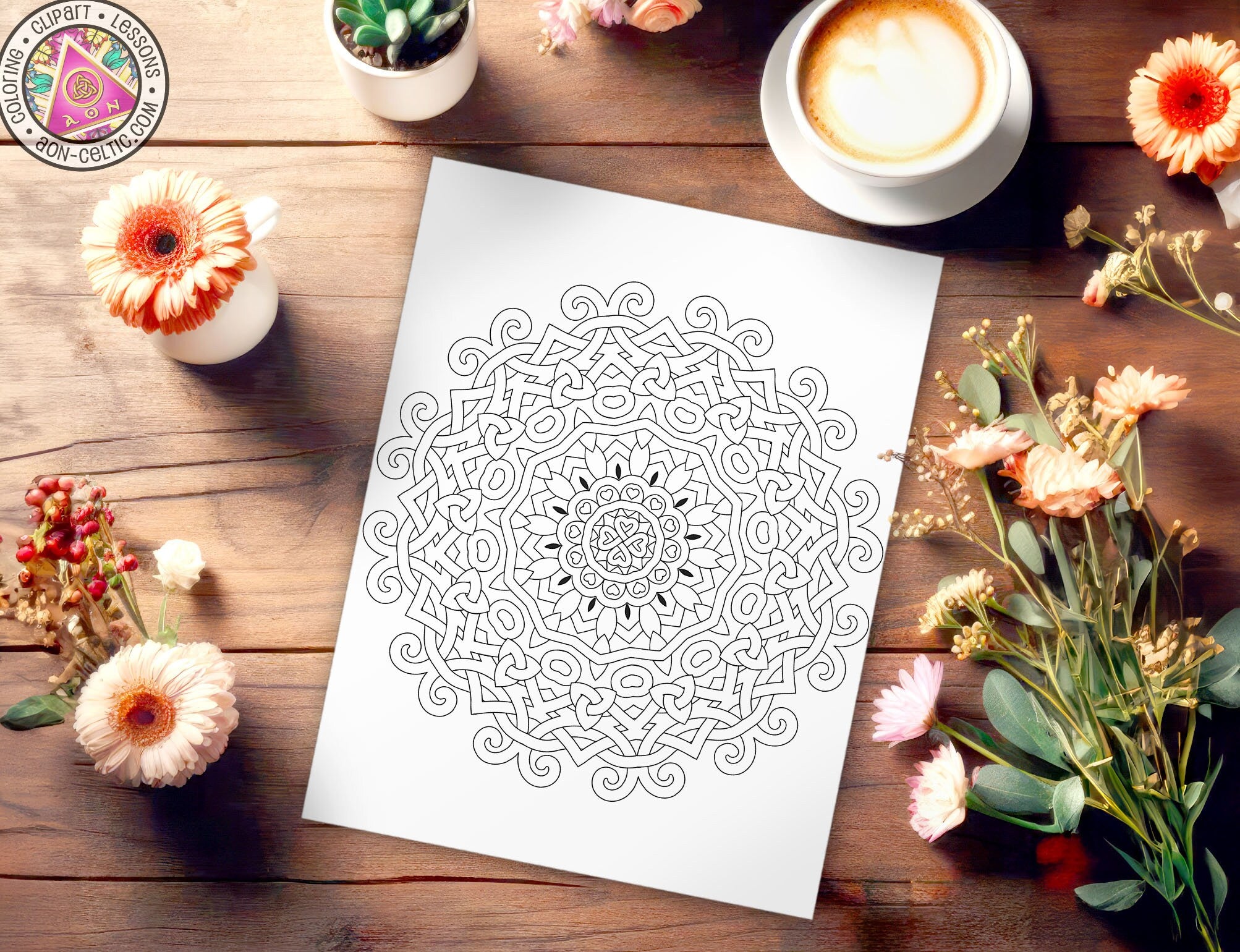a paper with a design on it next to flowers and a cup of coffee