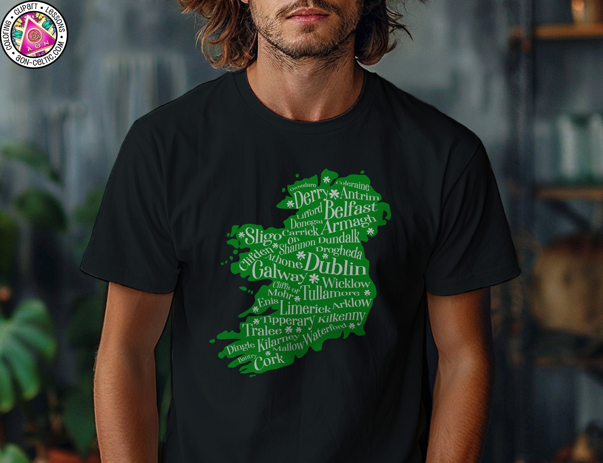 a man with long hair wearing a black t - shirt with green lettering