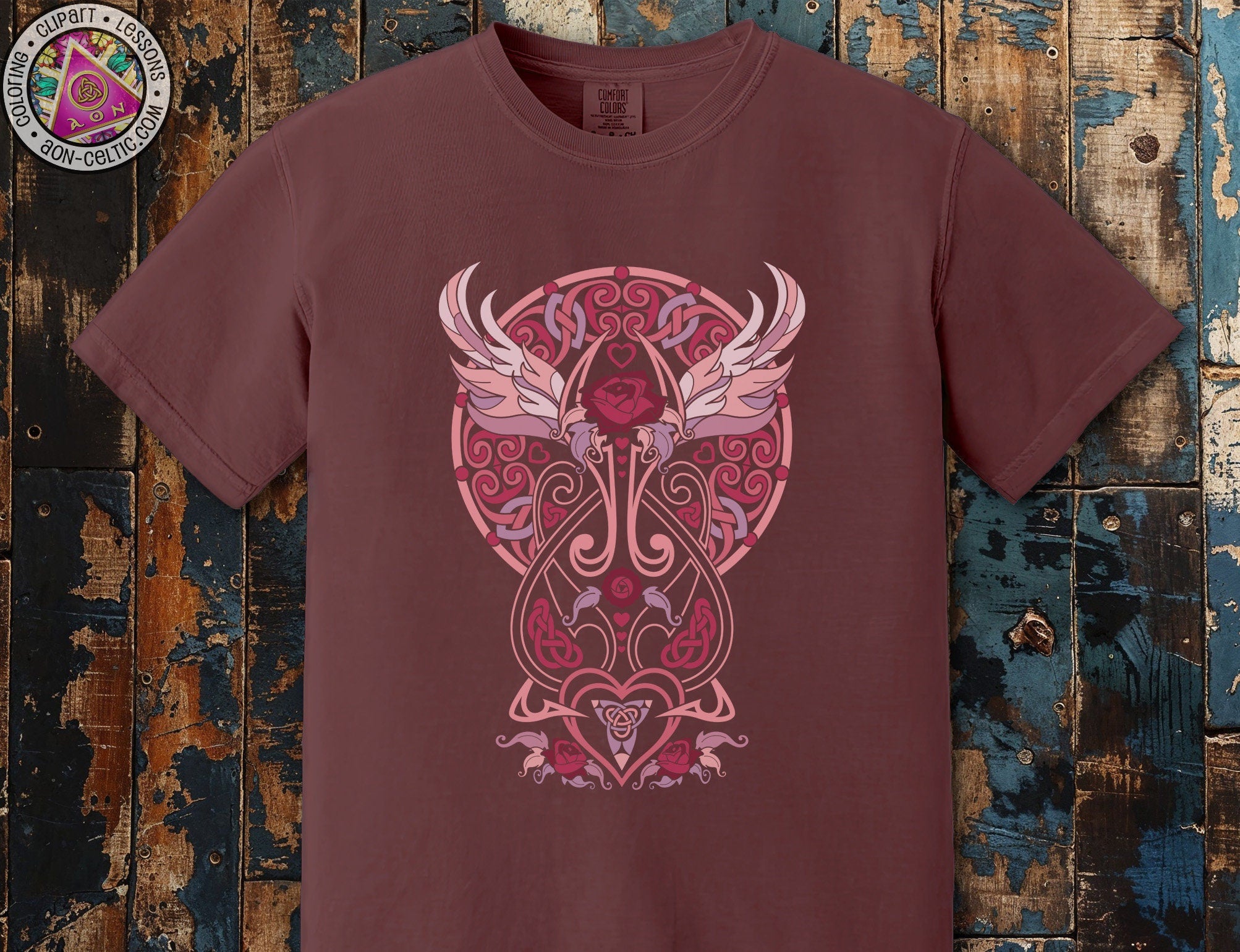 a maroon t - shirt with a design of an owl